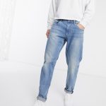 ASOS DESIGN stretch tapered jeans in mid wash blue | AS