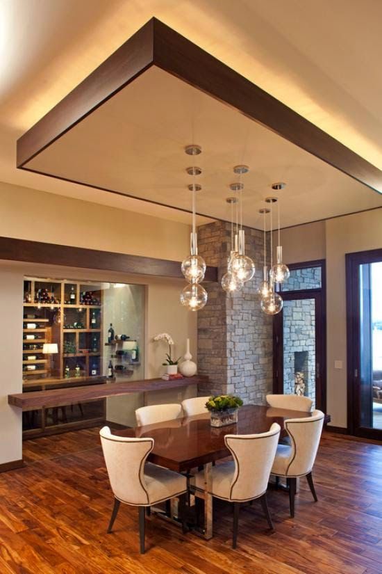 modern dining room with false ceiling designs and suspended lamps .