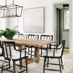 Beige Wood Plank Dining Table with Black Wooden Chairs .