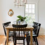 Chic cottage dining room features a farmhouse dining table lined .