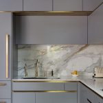 Contemporary gold tap in bespoke, smokey grey Roundhouse kitchen .