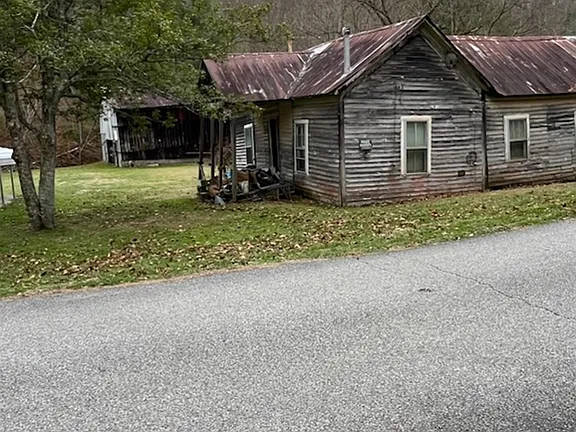 Expansive Wooded Acreage with Mobile Home and Barn on Paved Access