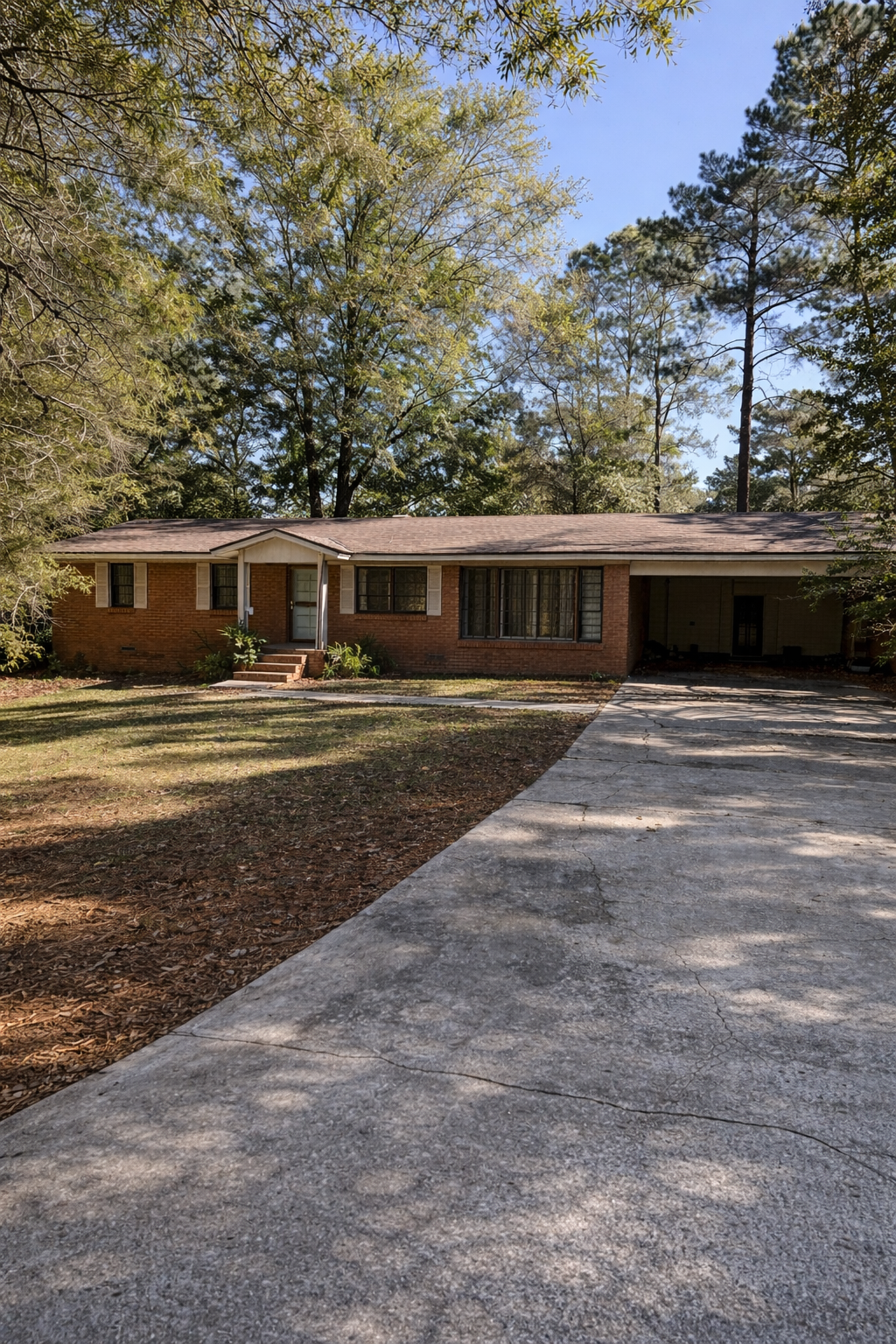 Charming Brick Ranch with Spacious Driveway and Serene Wooded Setting