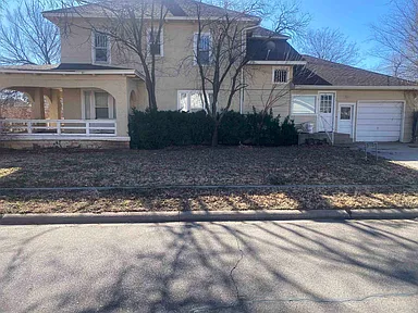 Charming Two-Story Home with Covered Porch and Attached Garage in a Quiet Neighborhood